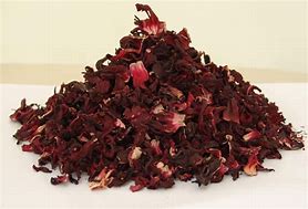 A pile of dried hibiscus petals on a light surface.
