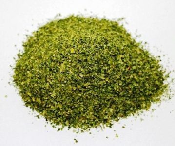 A pile of finely chopped green herbs on a white background.