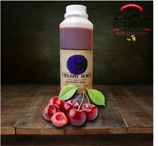 A bottle labeled "CHERRY BOMB Premium Signature Source Flavored Vodka" on a wooden table with whole cherries and one halved cherry in the foreground, and a dark background featuring the logo of "KETELKRAAL Distillery, Brewery, Braai-Supply Store".